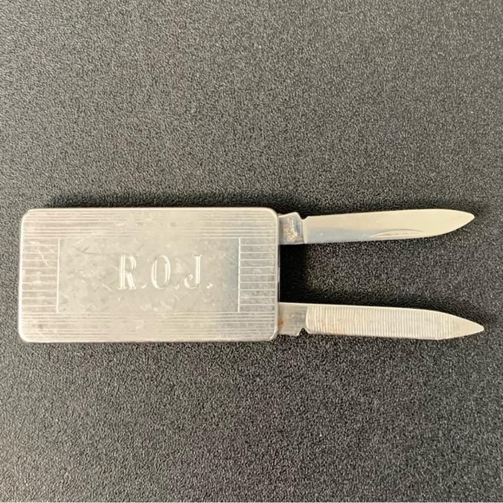 Imperial stainless steel money clip with knife and file.